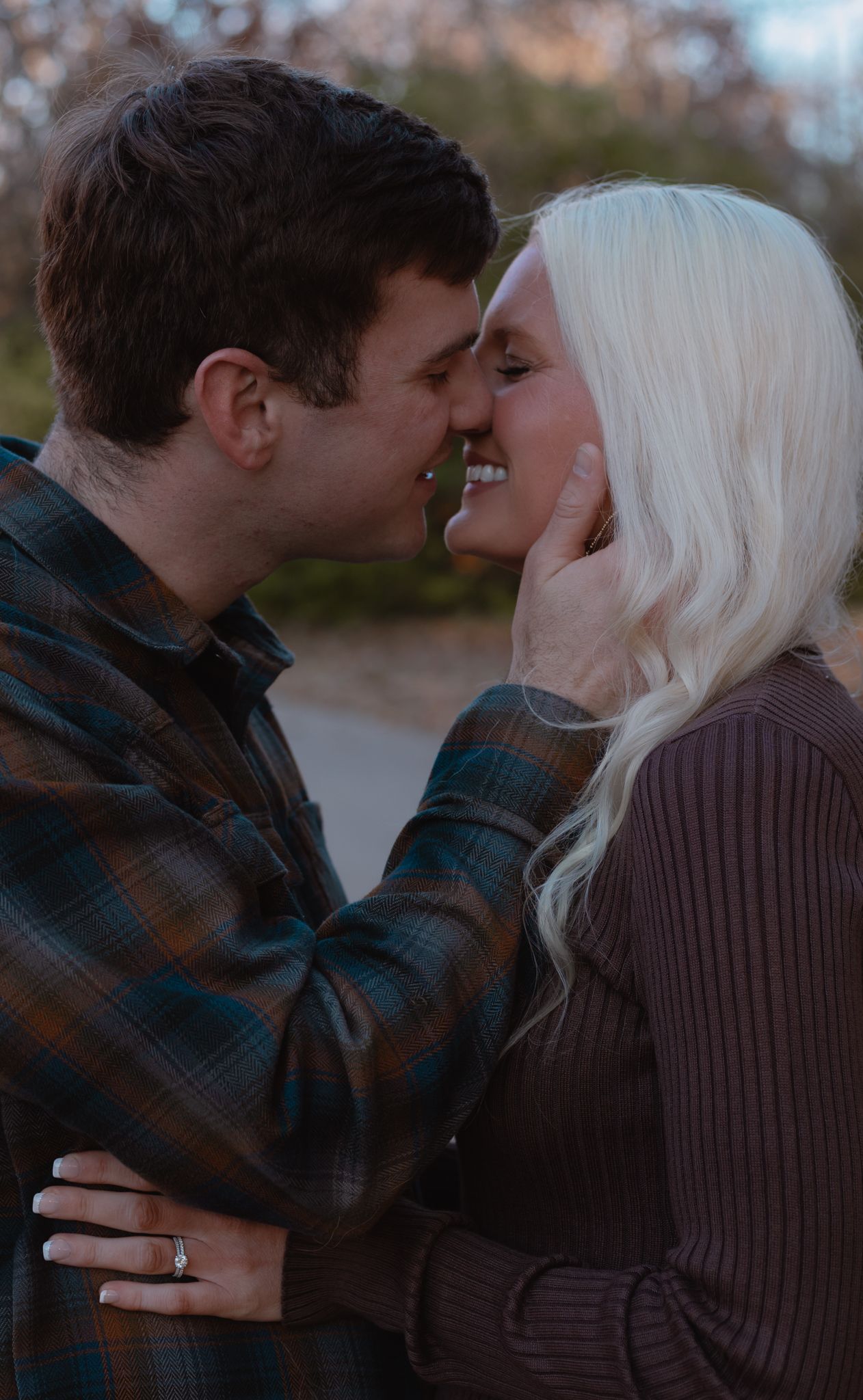 An intimate moment captured between two people in warm winter clothing.