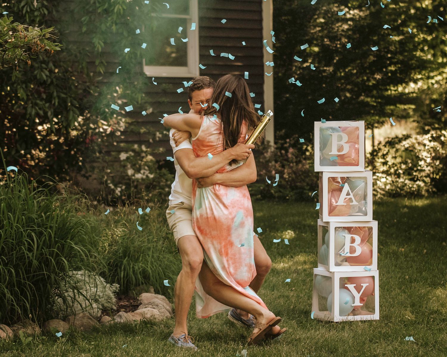 Romantic outdoor photoshoot with decorative letter boxes in a garden setting.