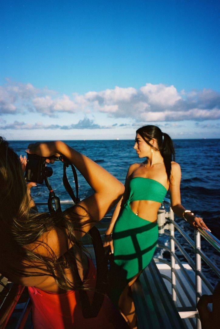 People enjoying a boat ride on blue waters under sunny skies.