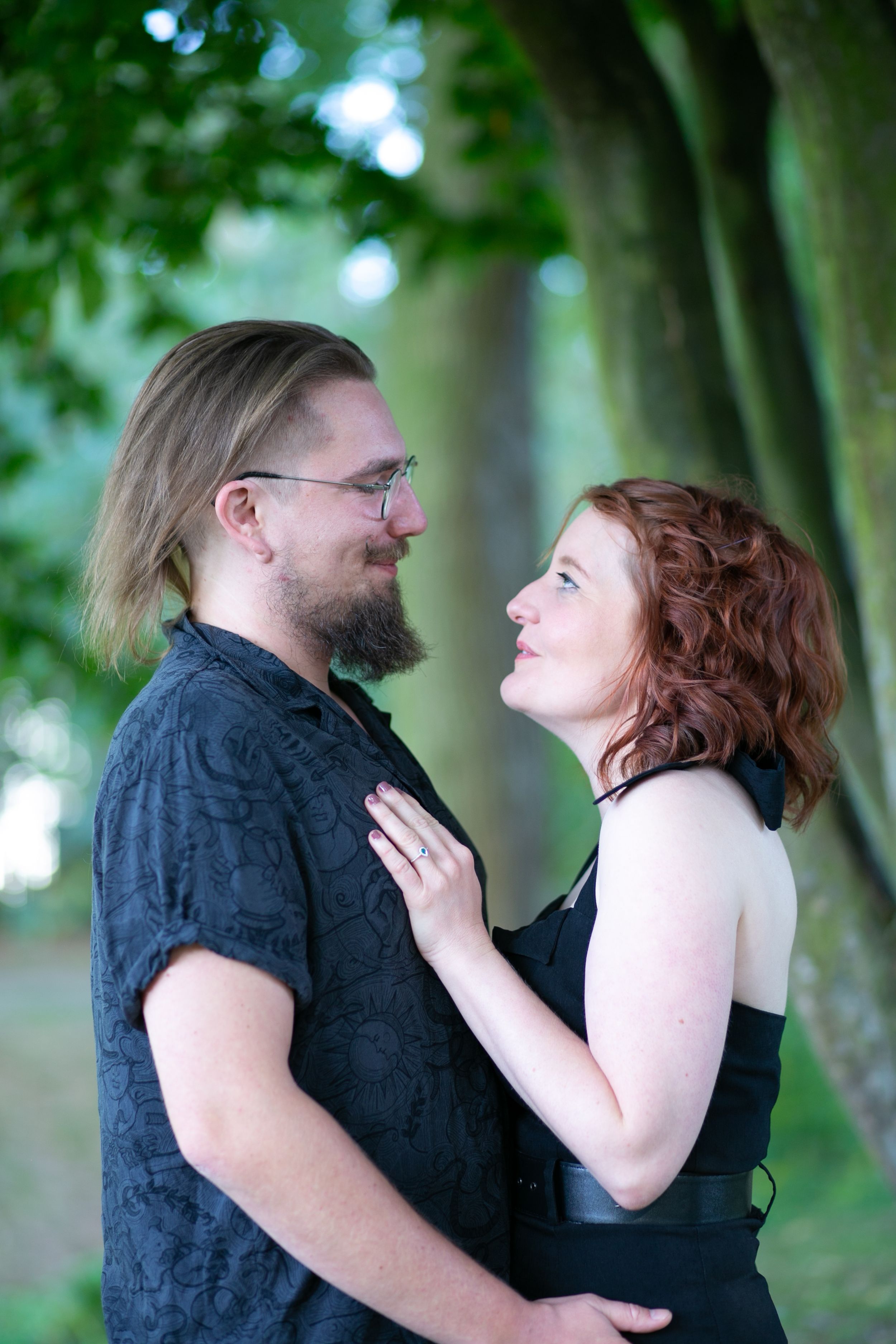 newly engaged couple looking into each others eyes