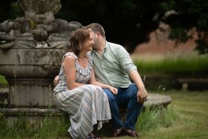 whispering engaged couple engagement ring at pre wedding engagement photoshoot