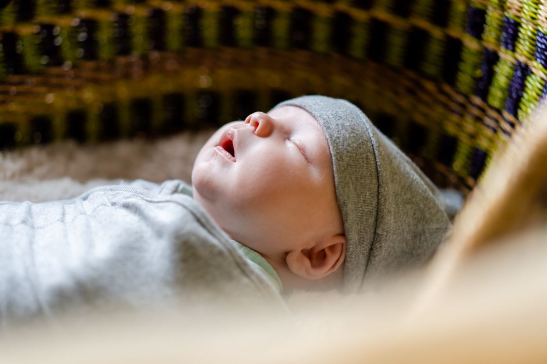 Baby boy lying in a moses basket