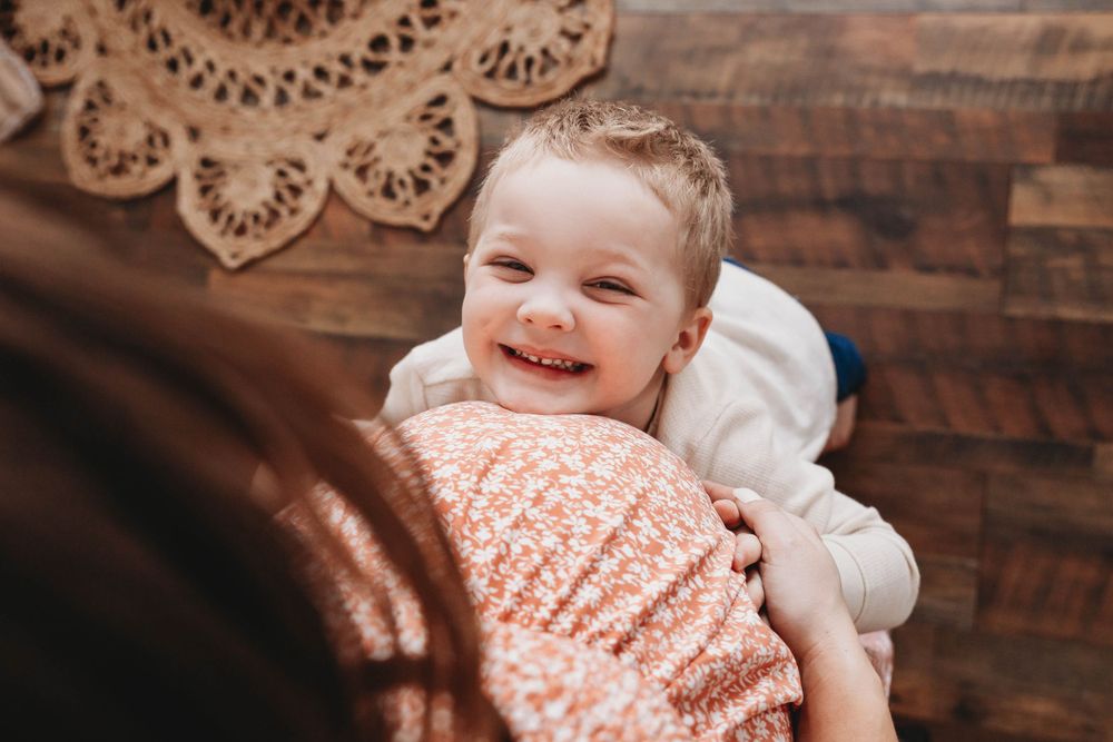 Series of candid moments showing joyful interaction between parent and child against a rustic backdrop.