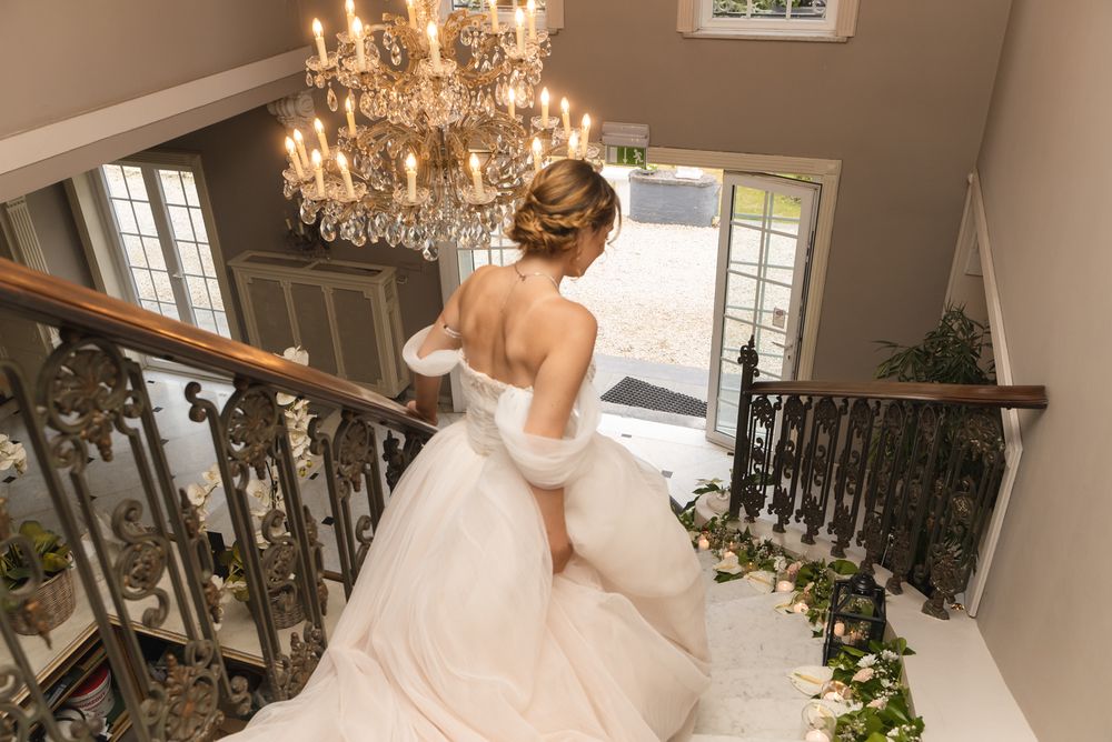 Interior shots of bride preparing in elegant room with crystal chandelier.