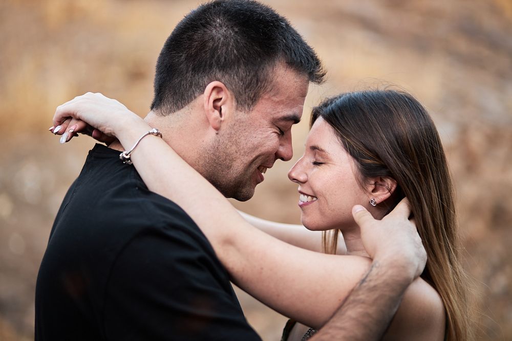 An intimate romantic moment captured between a couple during sunset.