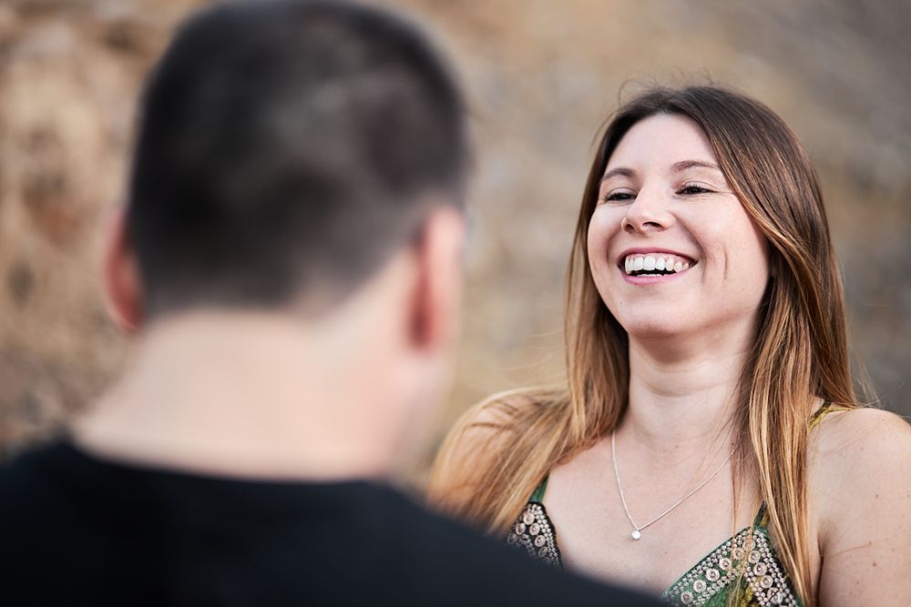 A joyful moment captured between a couple during an outdoor photoshoot.