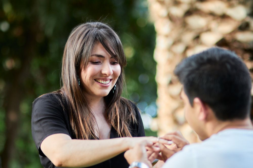 Candid moment of shared happiness between two people in a garden setting.