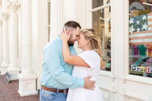 Couple embraces on the Strand in Galveston, TX during their engagement session.