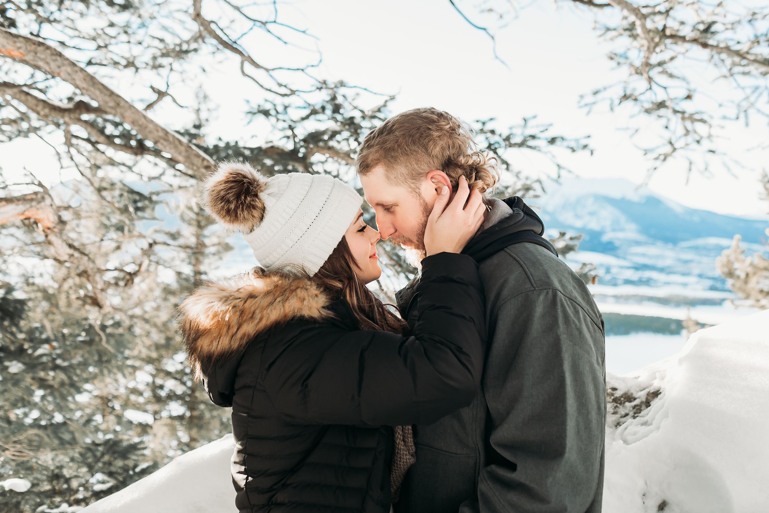 Engages couple touches their foreheads and noses during their engagement session in Breckenridge, CO.