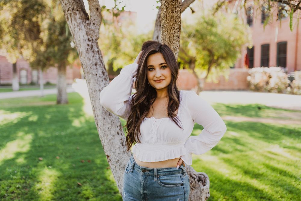 Sun-drenched garden portraits with trees and architectural elements in background.