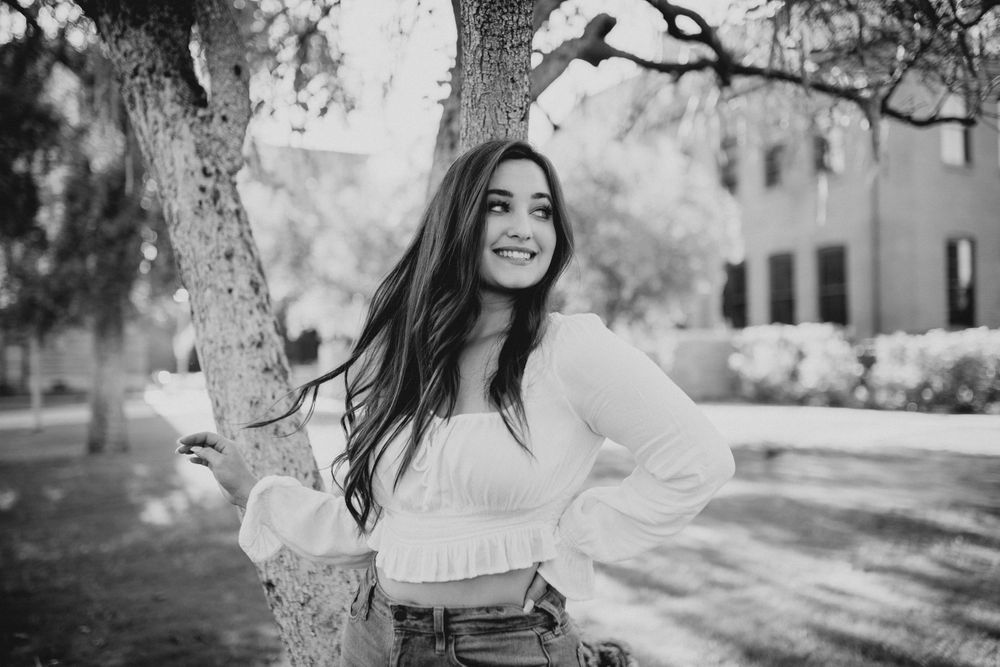 Black and white outdoor portraits with natural lighting and tree backdrop.