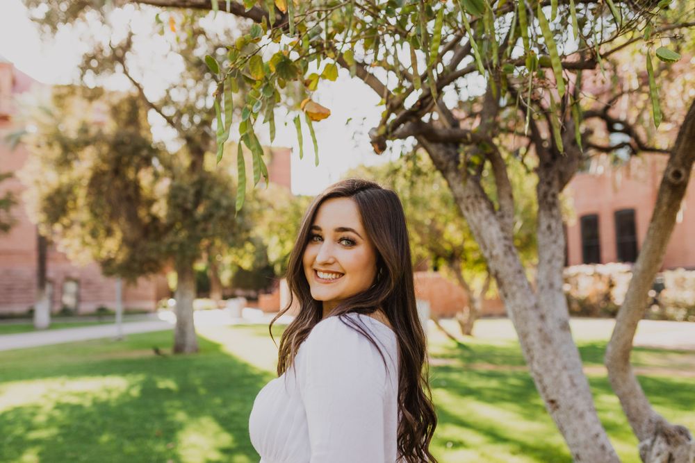 Candid moments captured in a park setting with trees and natural lighting.