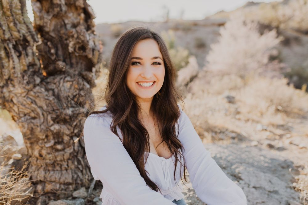 Natural outdoor portrait series featuring someone in a white top against a desert landscape backdrop.