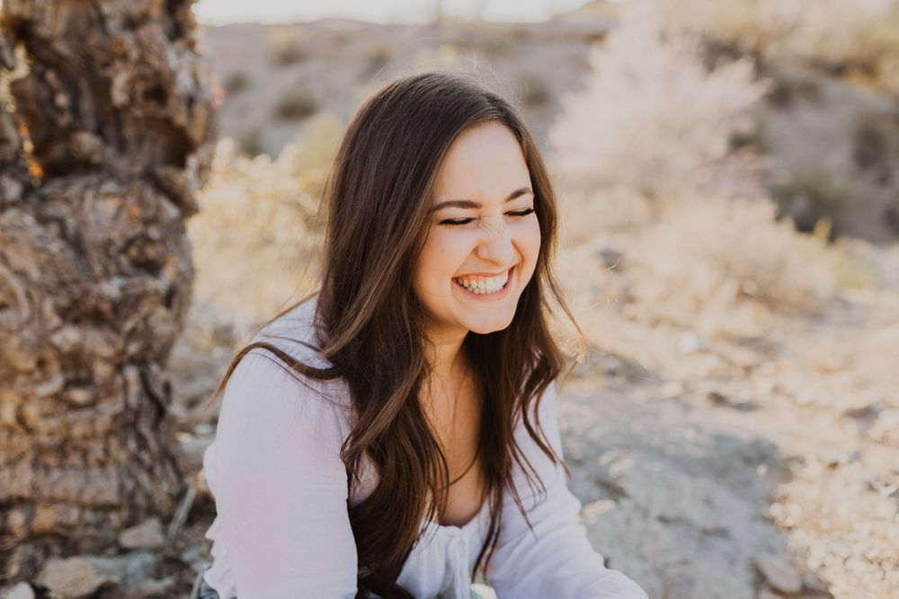 Candid portrait series showing joyful expressions against a desert background.