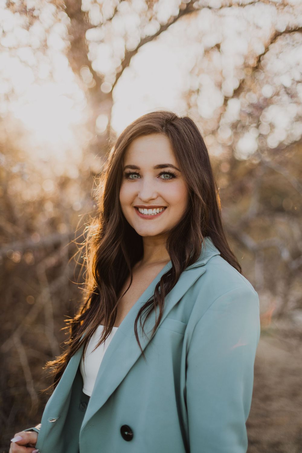 Outdoor portrait series featuring someone in a mint green blazer during golden hour.