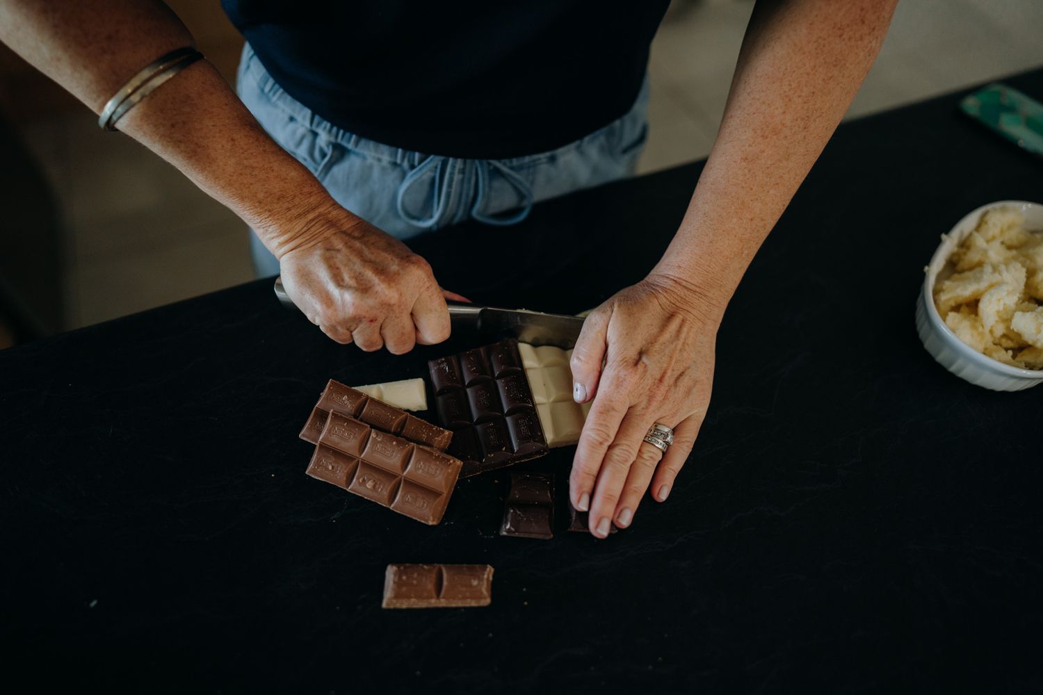 woman chopping chocolate on the bench