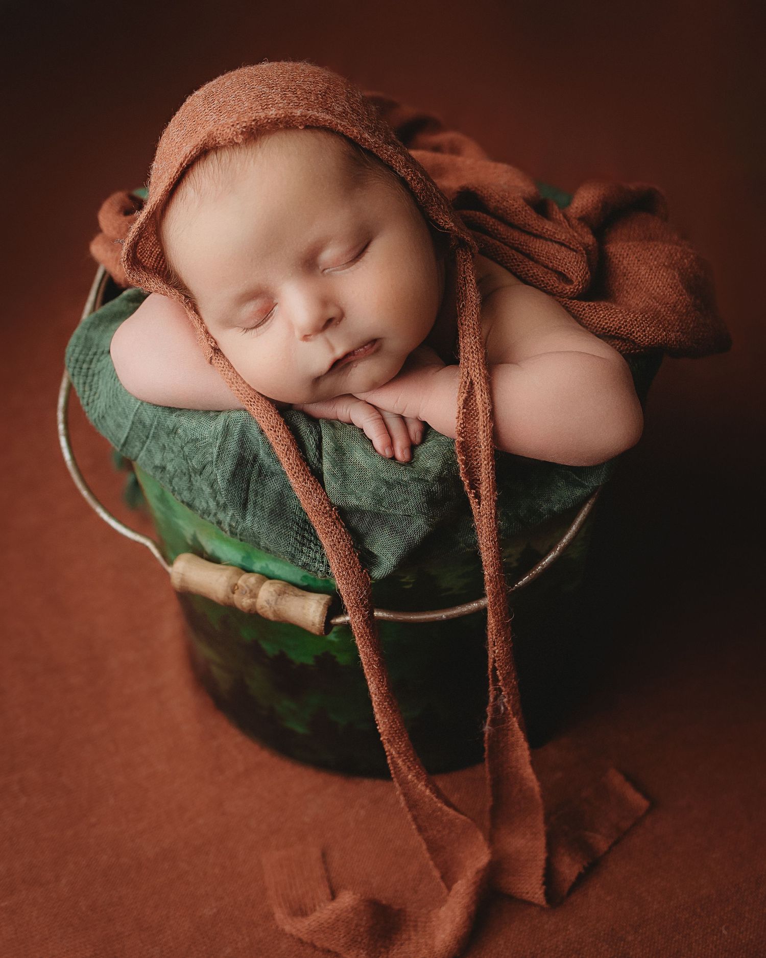 Professional newborn photo - baby in bucket
