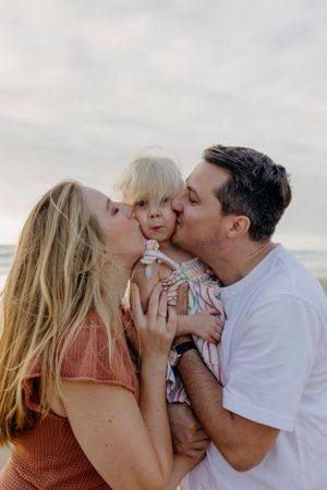 Sweet family moments captured in a series of loving interactions at the beach.