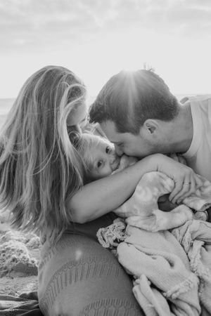 Intimate black and white family portrait showing love and connection on a sunny day.