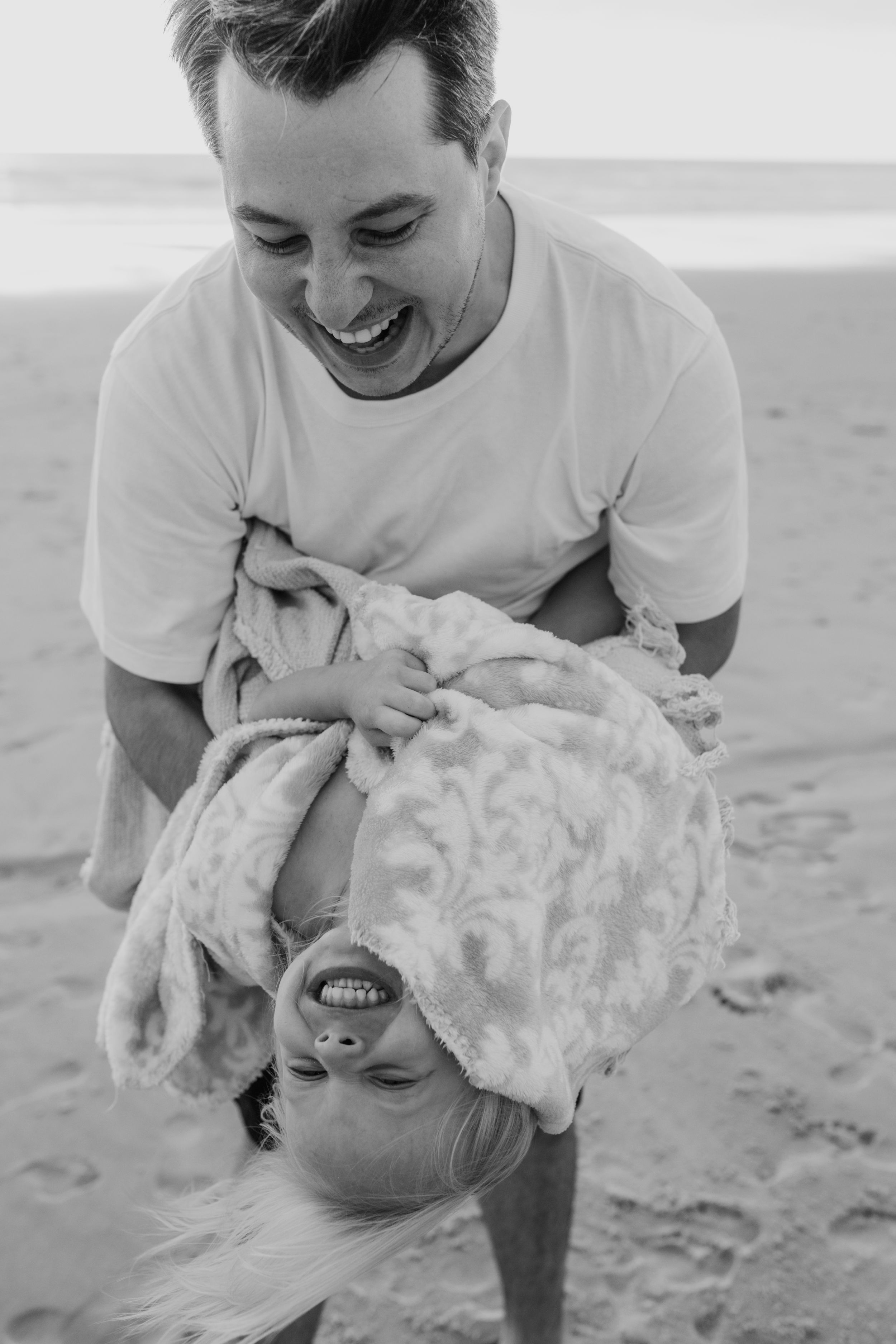 Playful black and white photos showing joyful interactions on the beach.