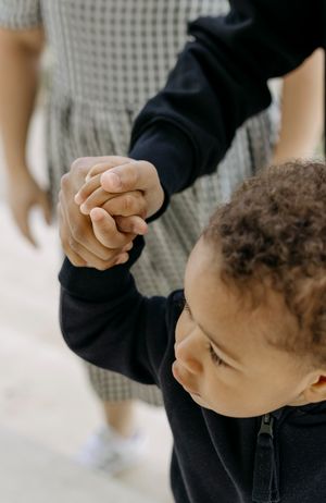 Close-up of hands holding together in a touching moment of connection.
