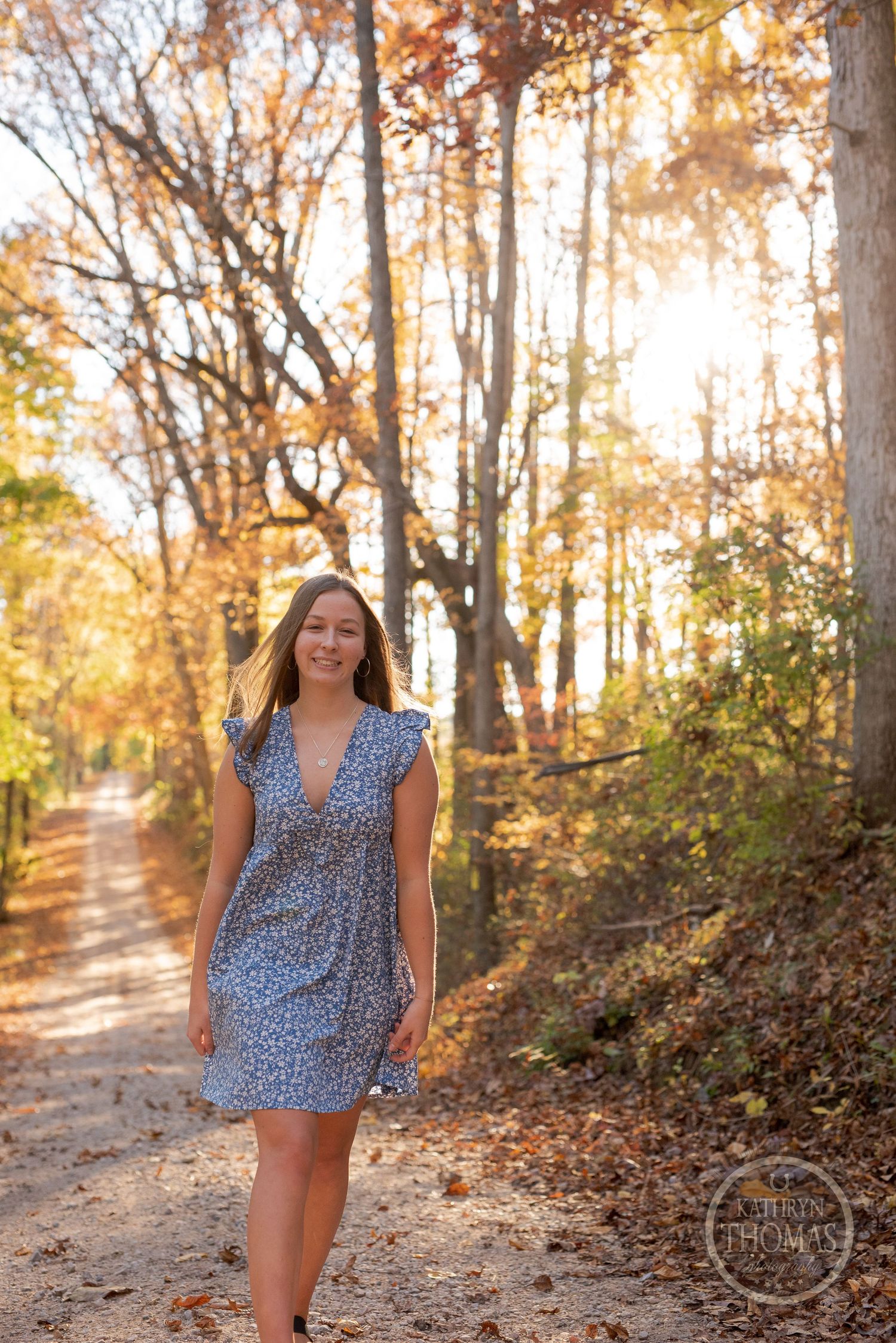 A casual walk captured on a sunlit autumn path with warm golden tones and falling leaves.