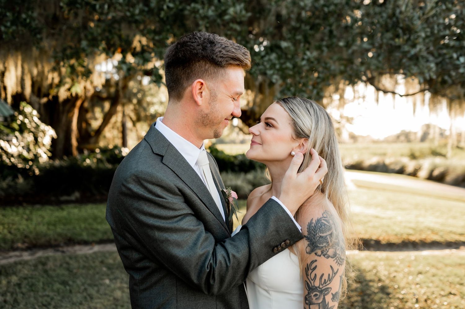 A couple shares romantic moments during their outdoor wedding photography session at golden hour.
