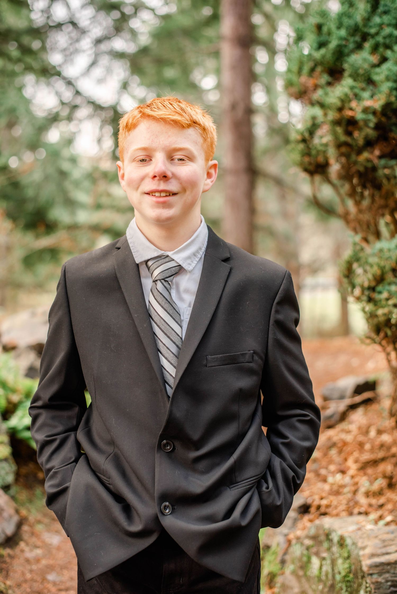 Professional outdoor photographs in a wooded setting with evergreen trees and natural lighting.