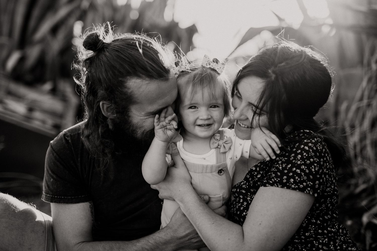 Intimate family moments captured in black and white photography outdoors.