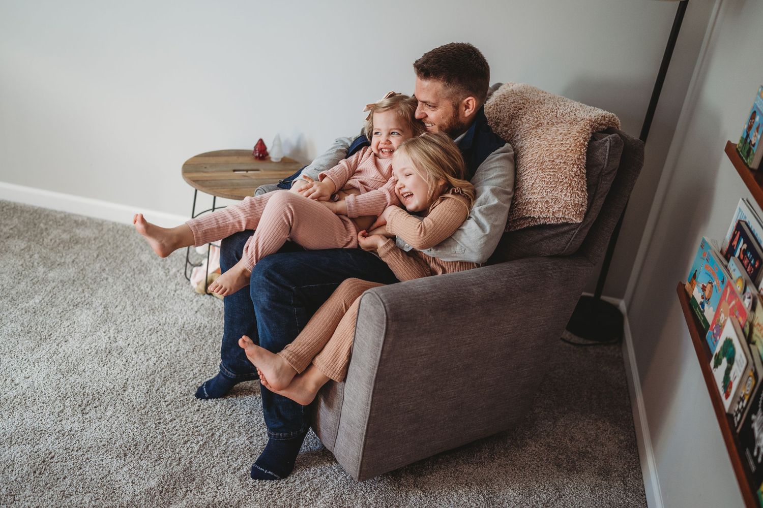 Candid family moments shared on a comfortable sofa in a bright, modern living space.