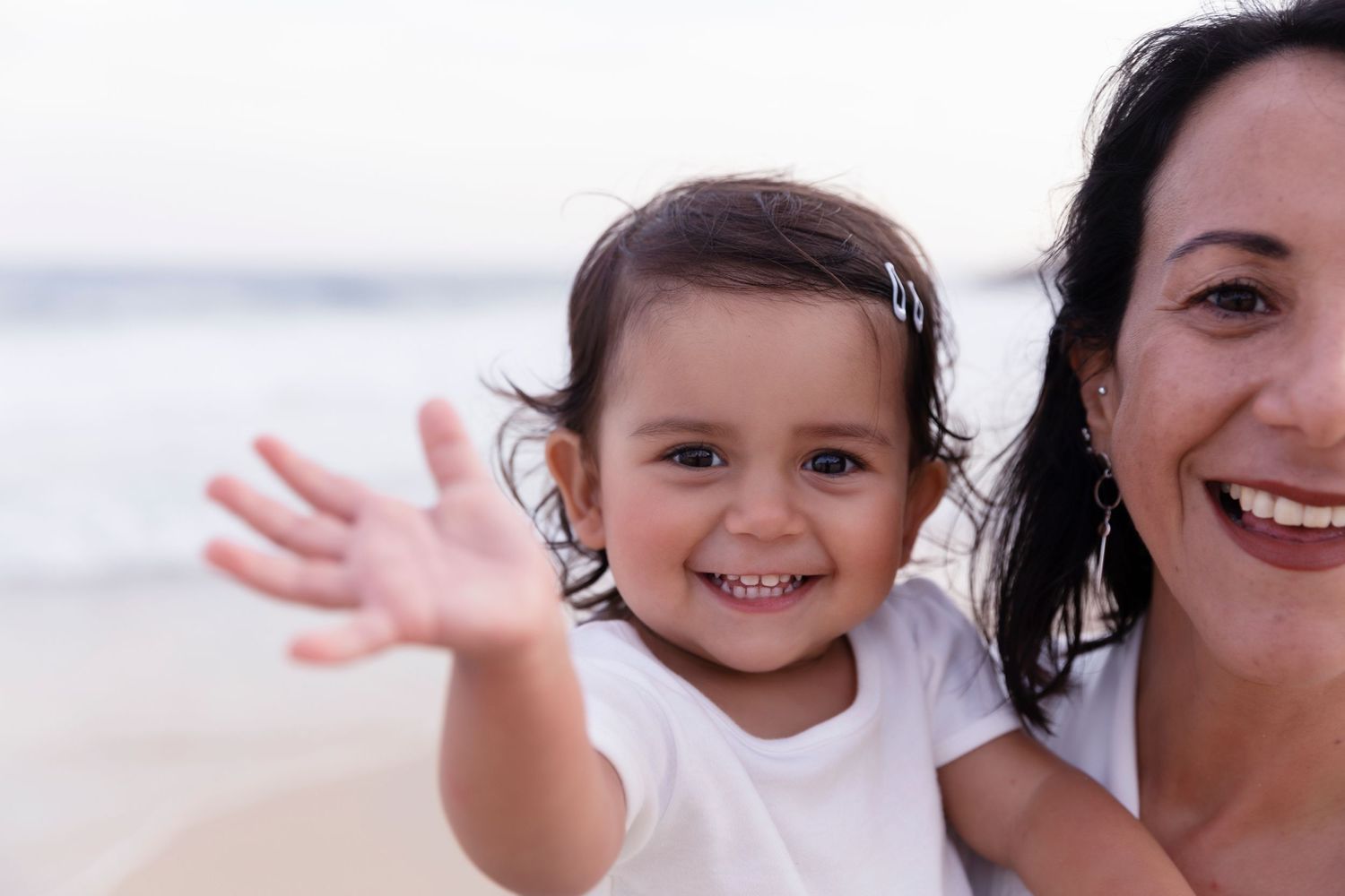 A joyful beach moment captured with waves in the background.