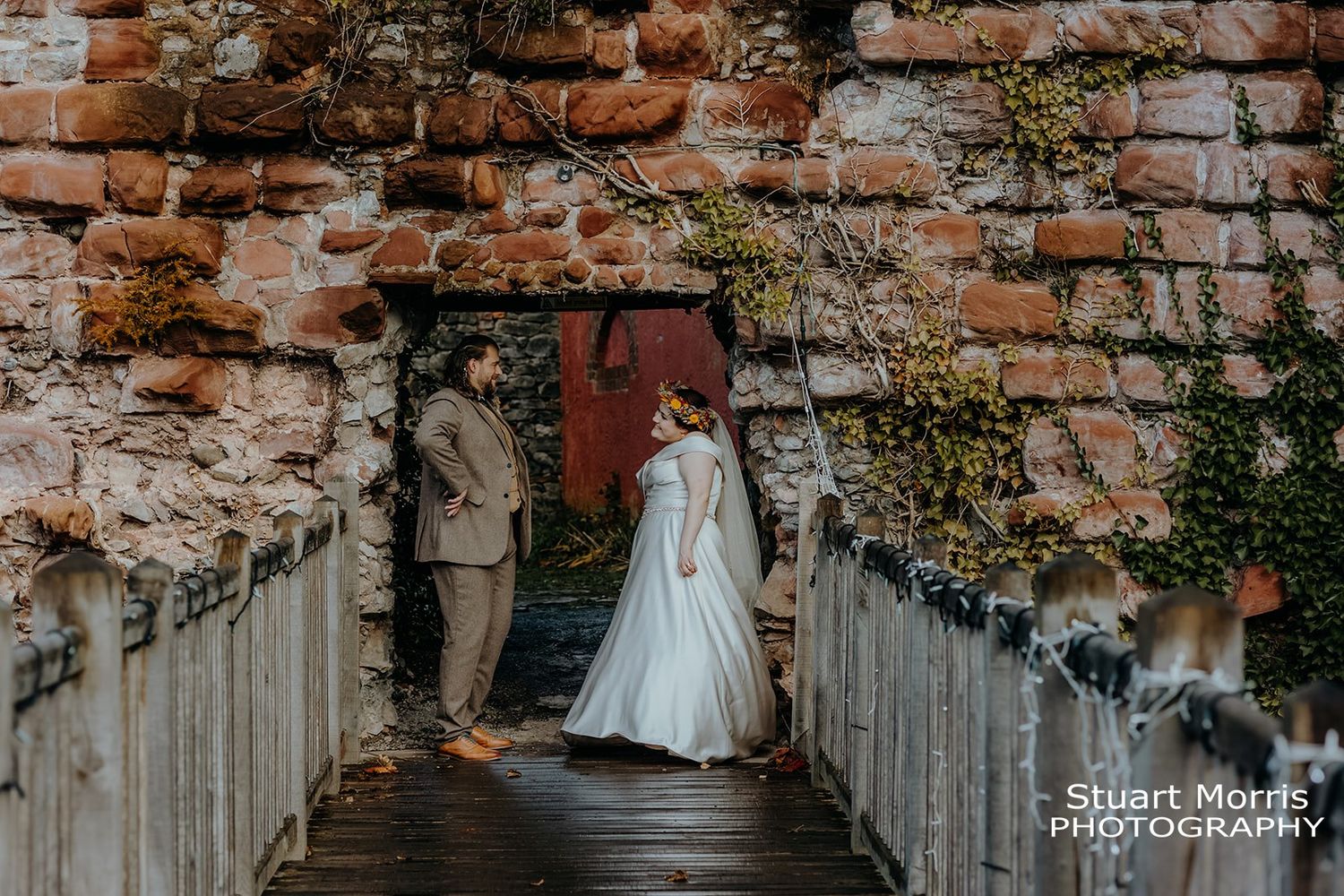 bride and groom have fun in the gardens at Ruthin castle. relaxed portraits by Stuart Morris Photography