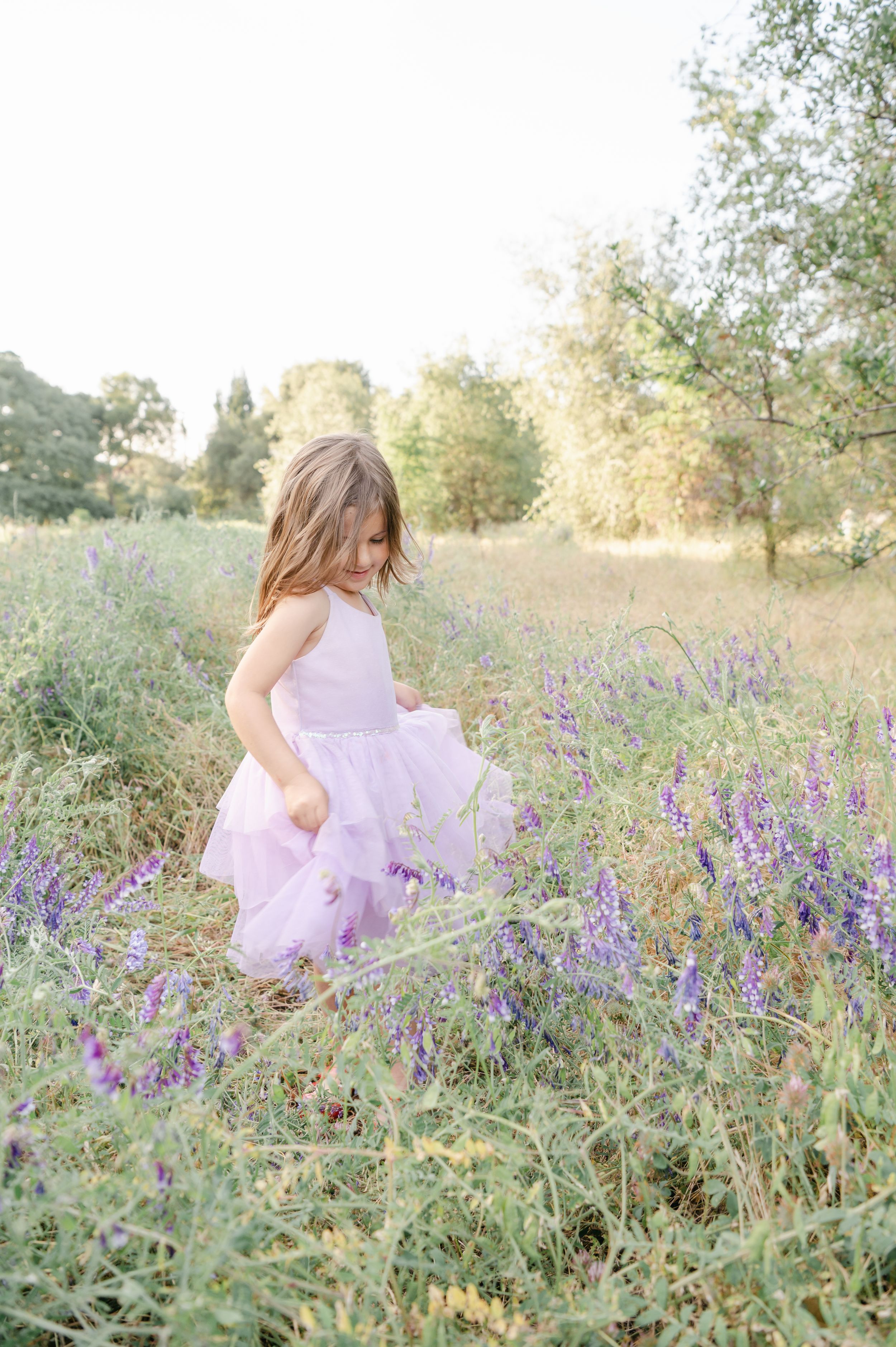 Young girl twirl in flowers, playing in flowers, spring flowers, girl birthday photography, California photographer.