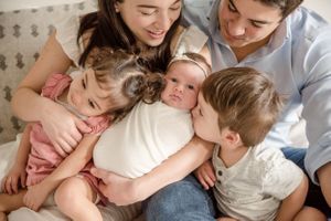 family pose with newborn, sibling love