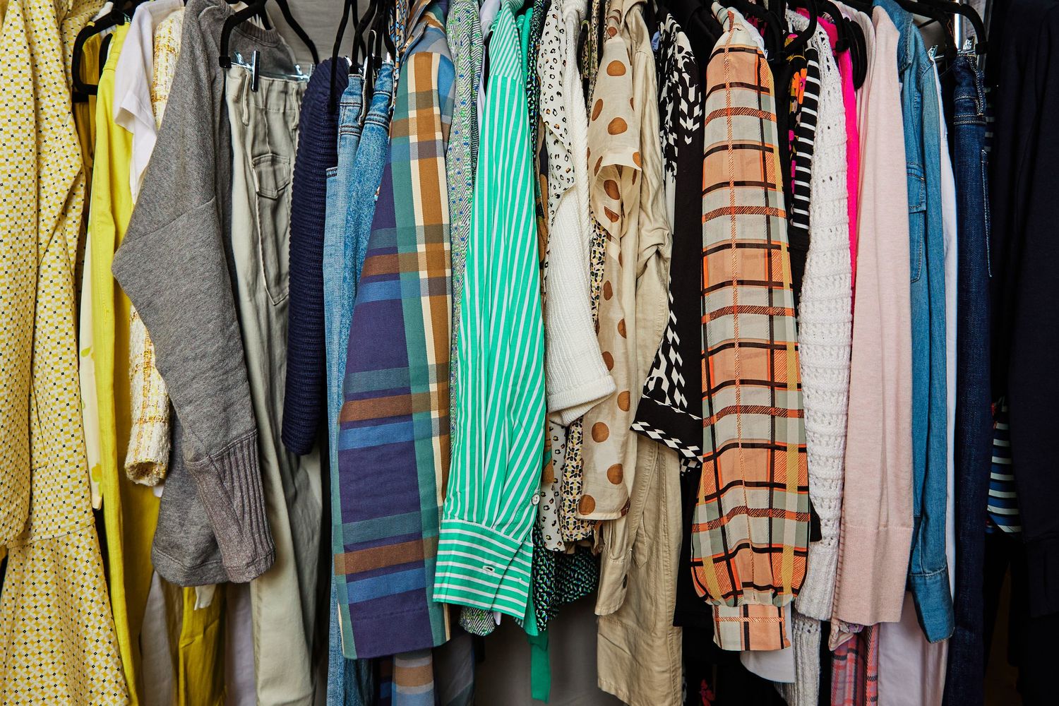 Colorful wardrobe rack displaying diverse clothing items hanging neatly in a row.