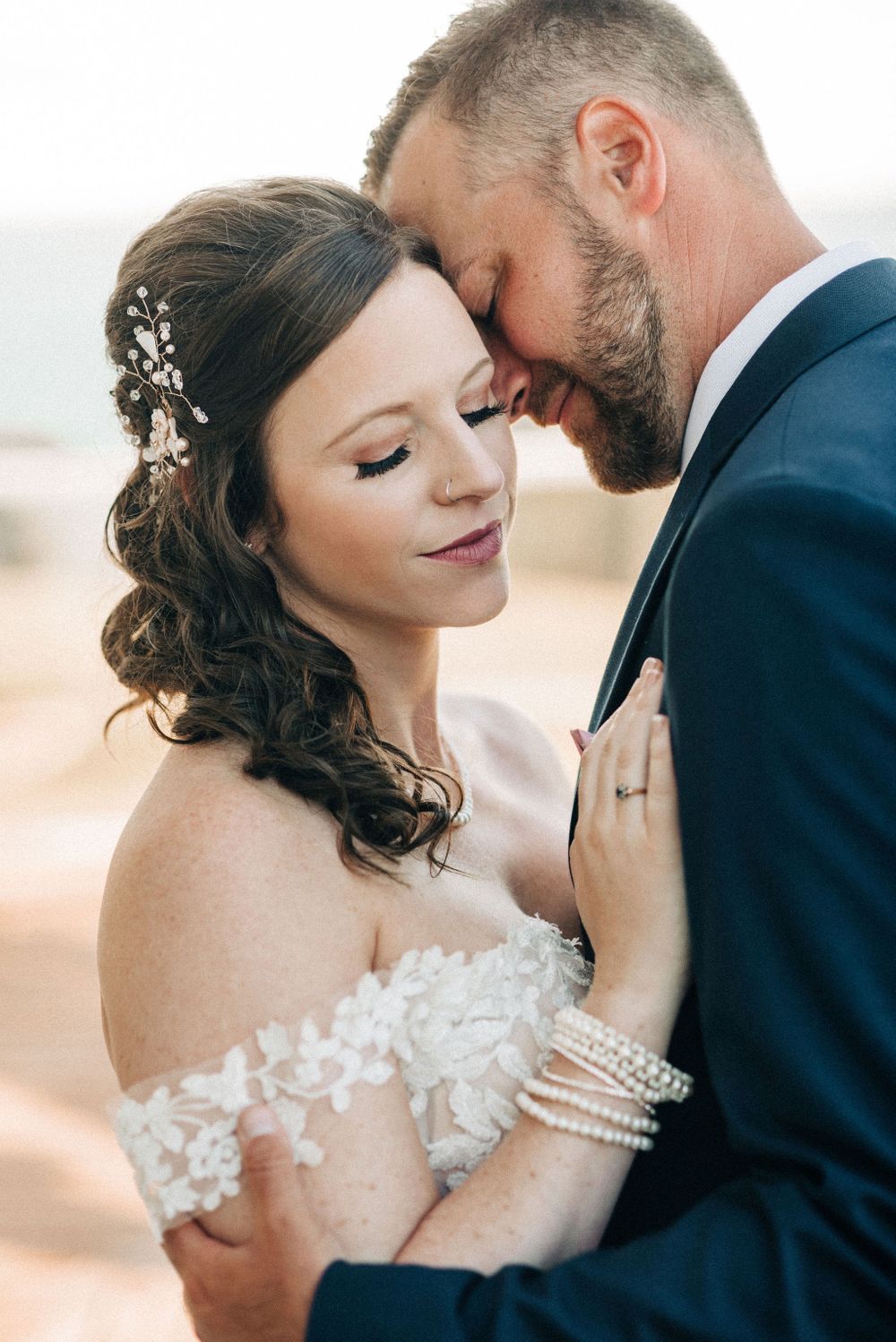 Intimate wedding portrait showing tender moment between newlyweds.
