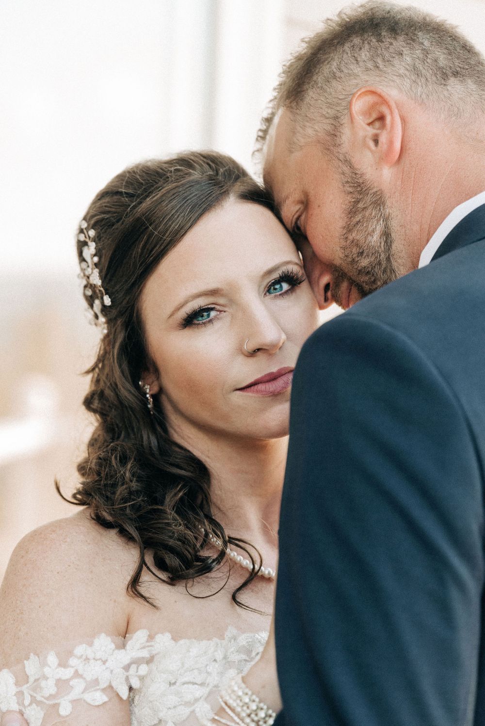 Close-up wedding photography of elegant couple sharing intimate moment.