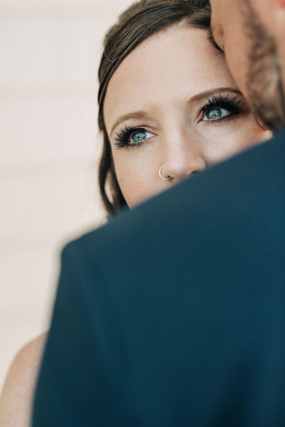 Close-up artistic wedding photo showing eye detail and intimate pose.