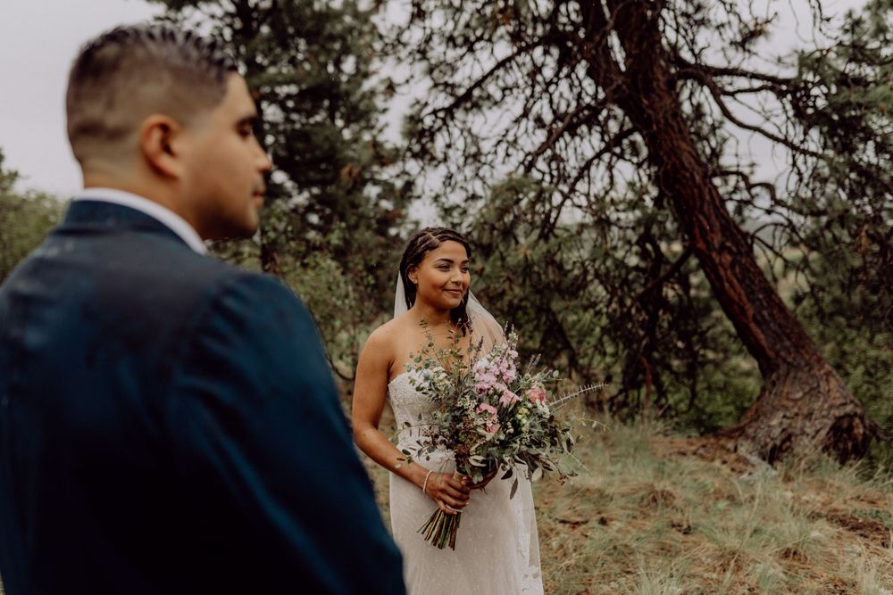 Intimate wedding ceremony moment captured in a wooded outdoor setting.