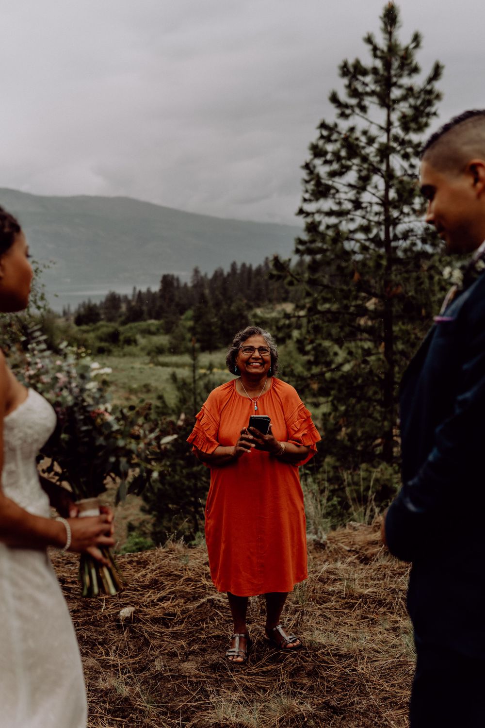A joyful moment during an outdoor mountain wedding ceremony.