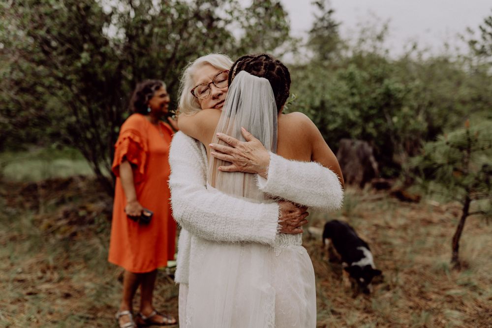 Emotional embraces shared during a mountain wedding celebration.