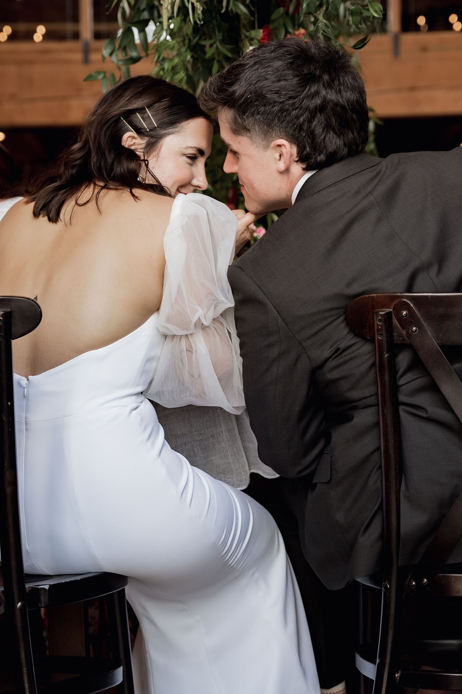 A romantic moment shared between a couple in formal attire at an elegant venue.