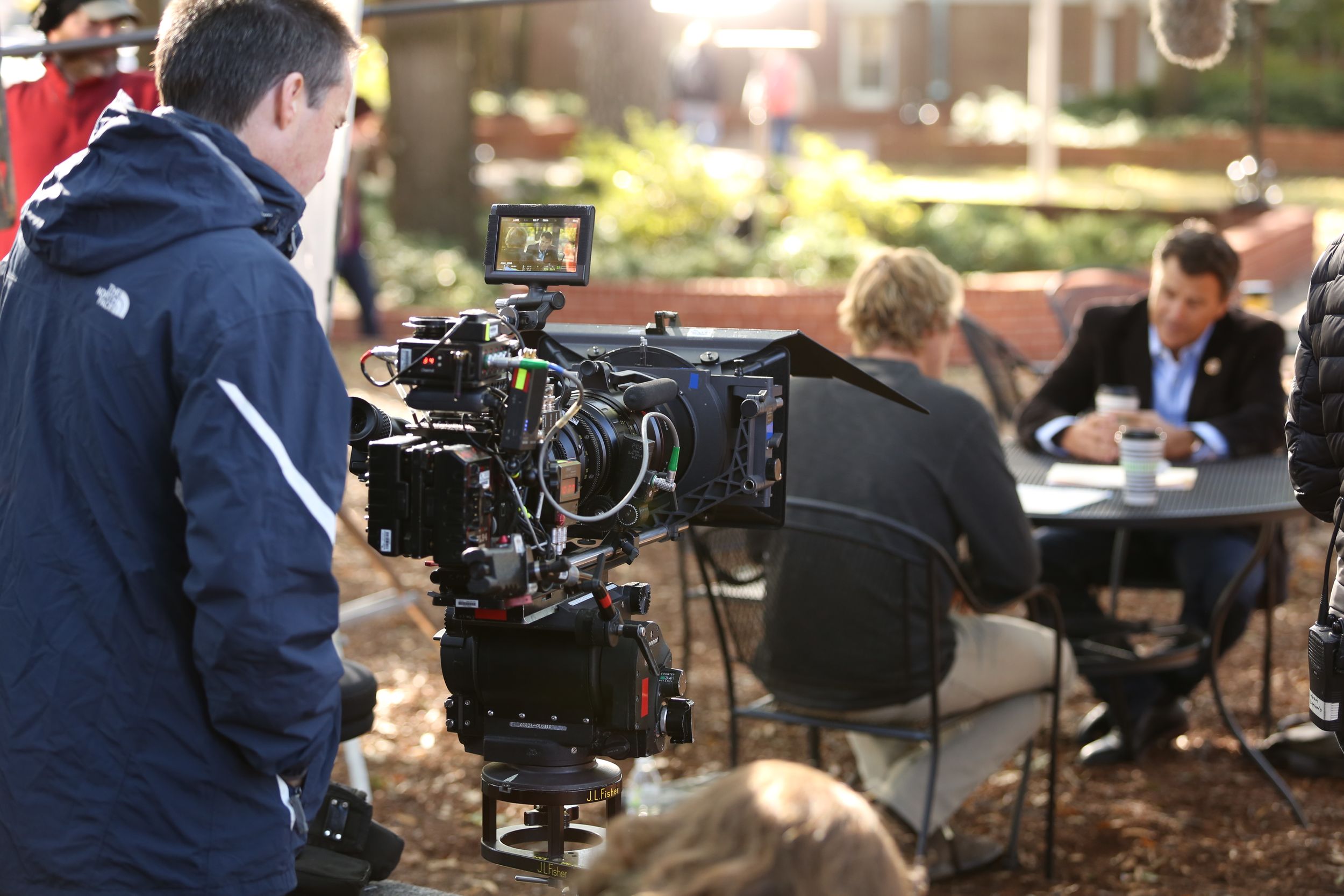 Film production crew working with professional camera equipment in an indoor setting.