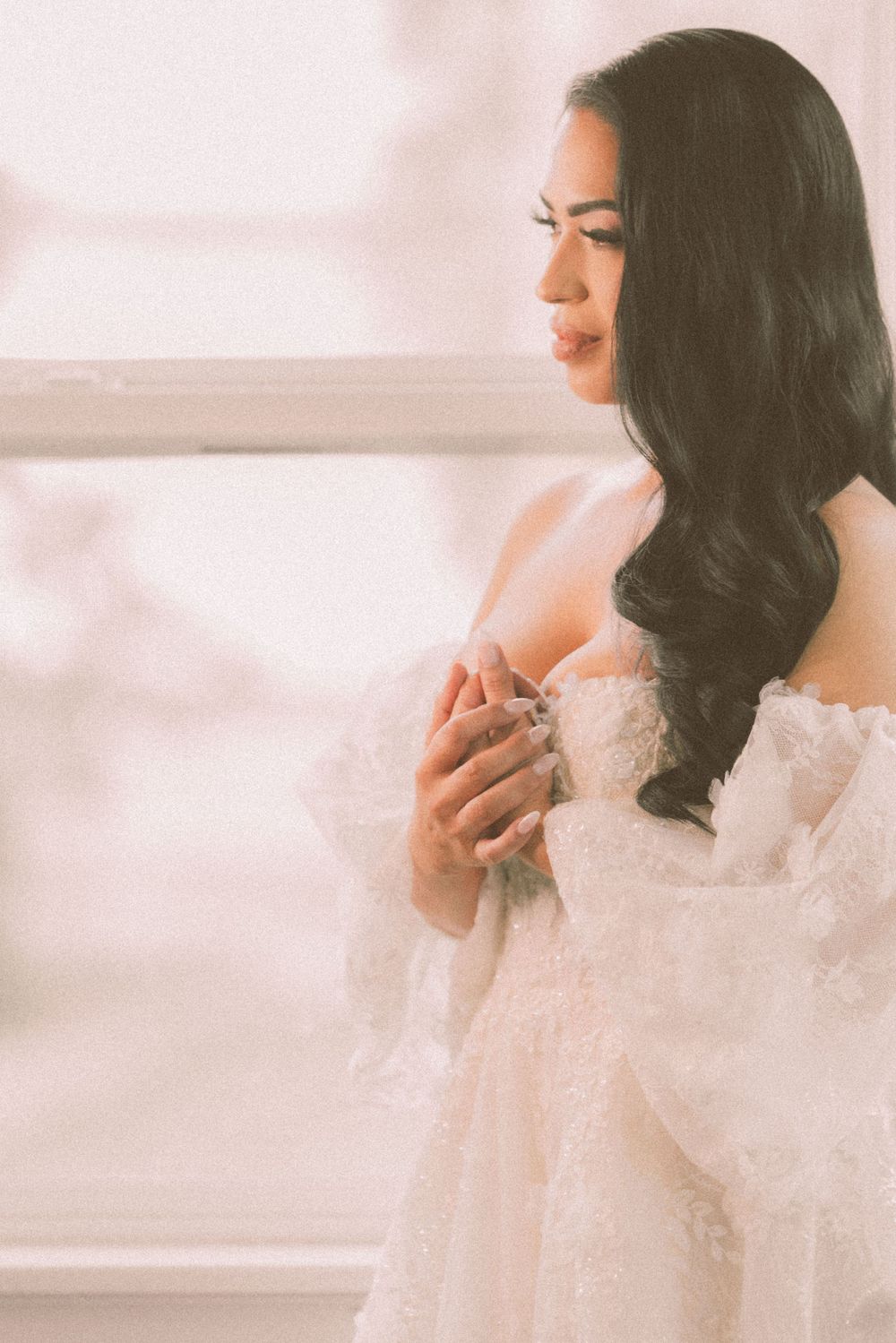Dreamy boudoir portrait featuring lace details and soft lighting in romantic setting.