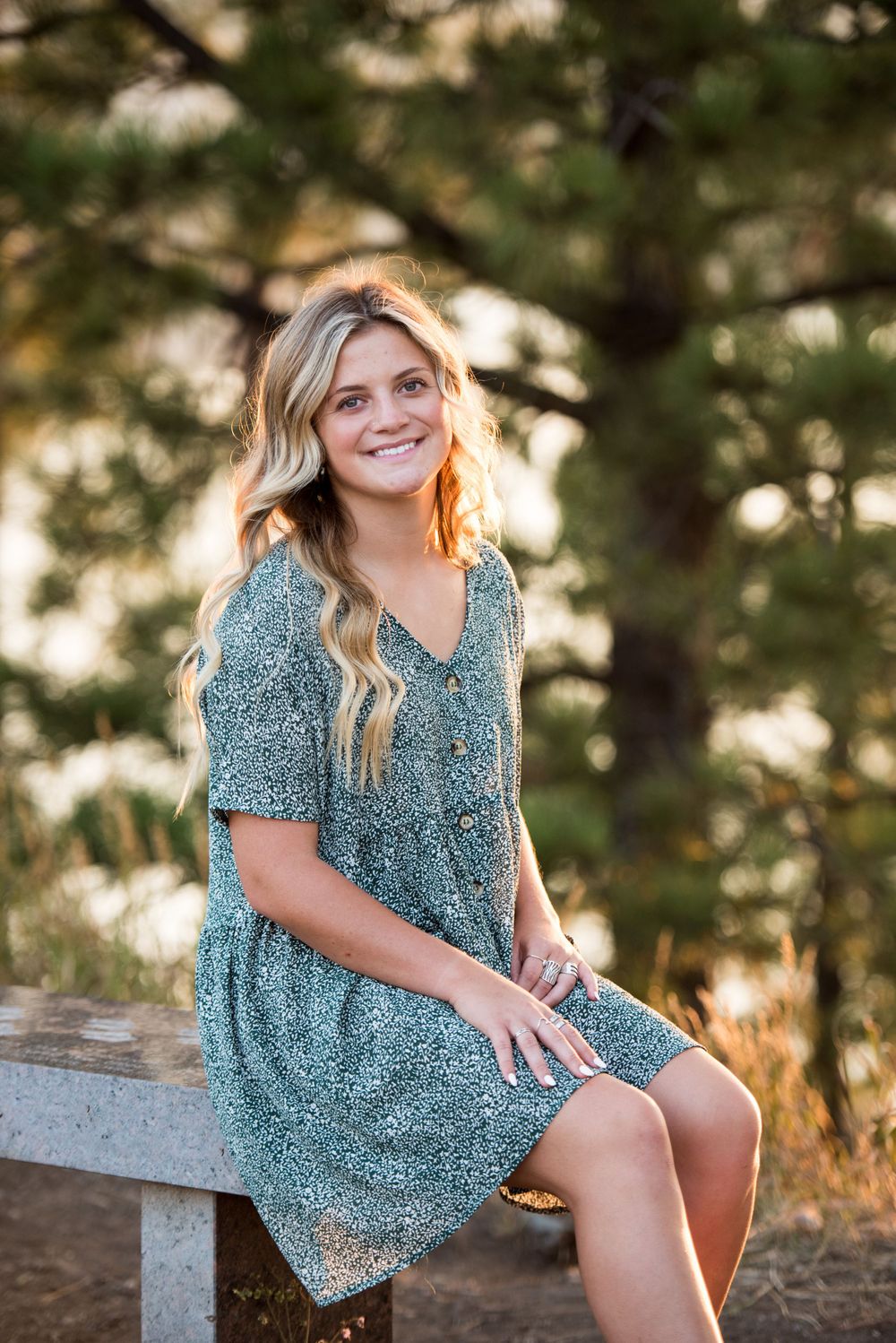 Casual portrait session featuring a teal floral dress against a natural sunset backdrop.