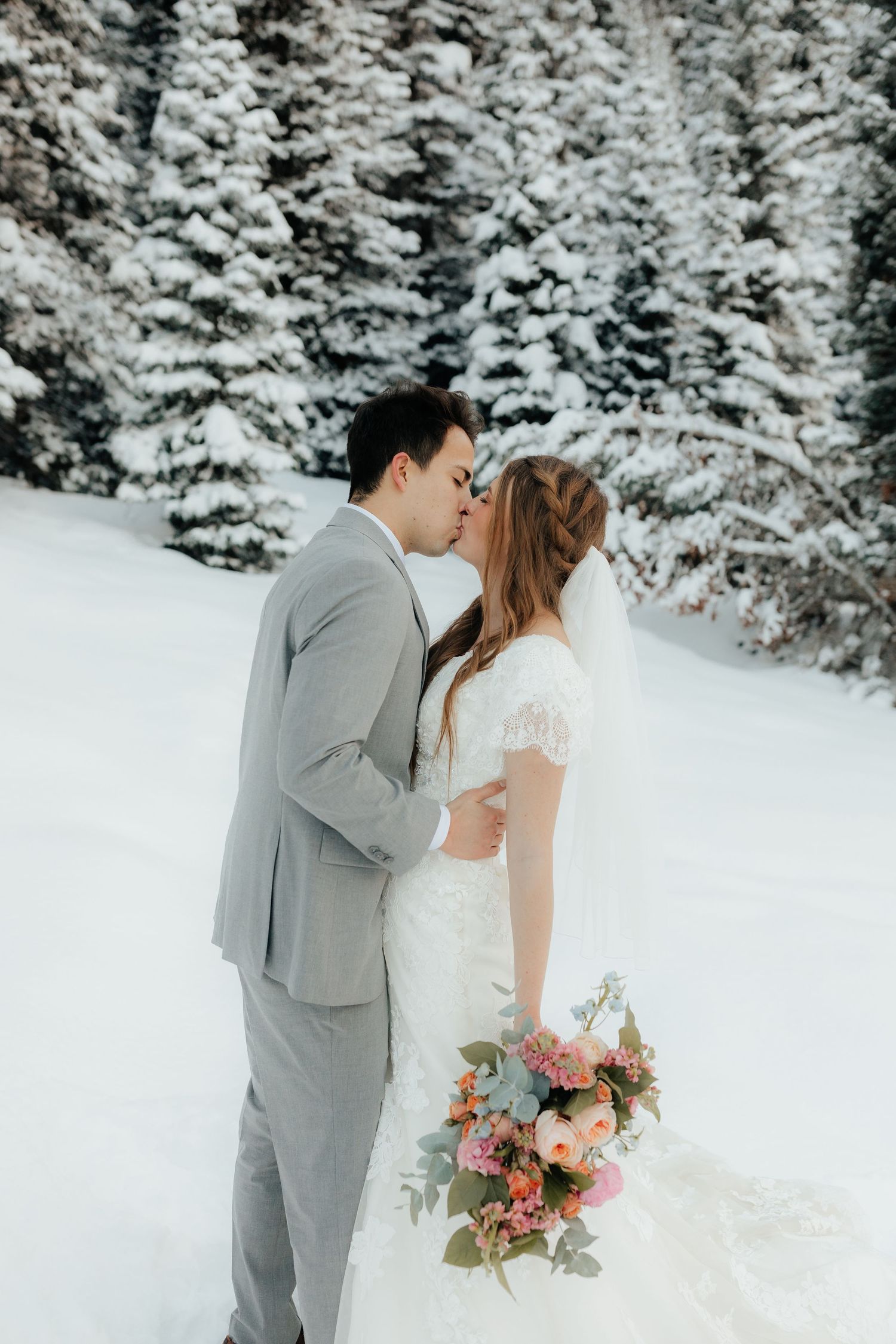 Bride and Groom kissing in snow
