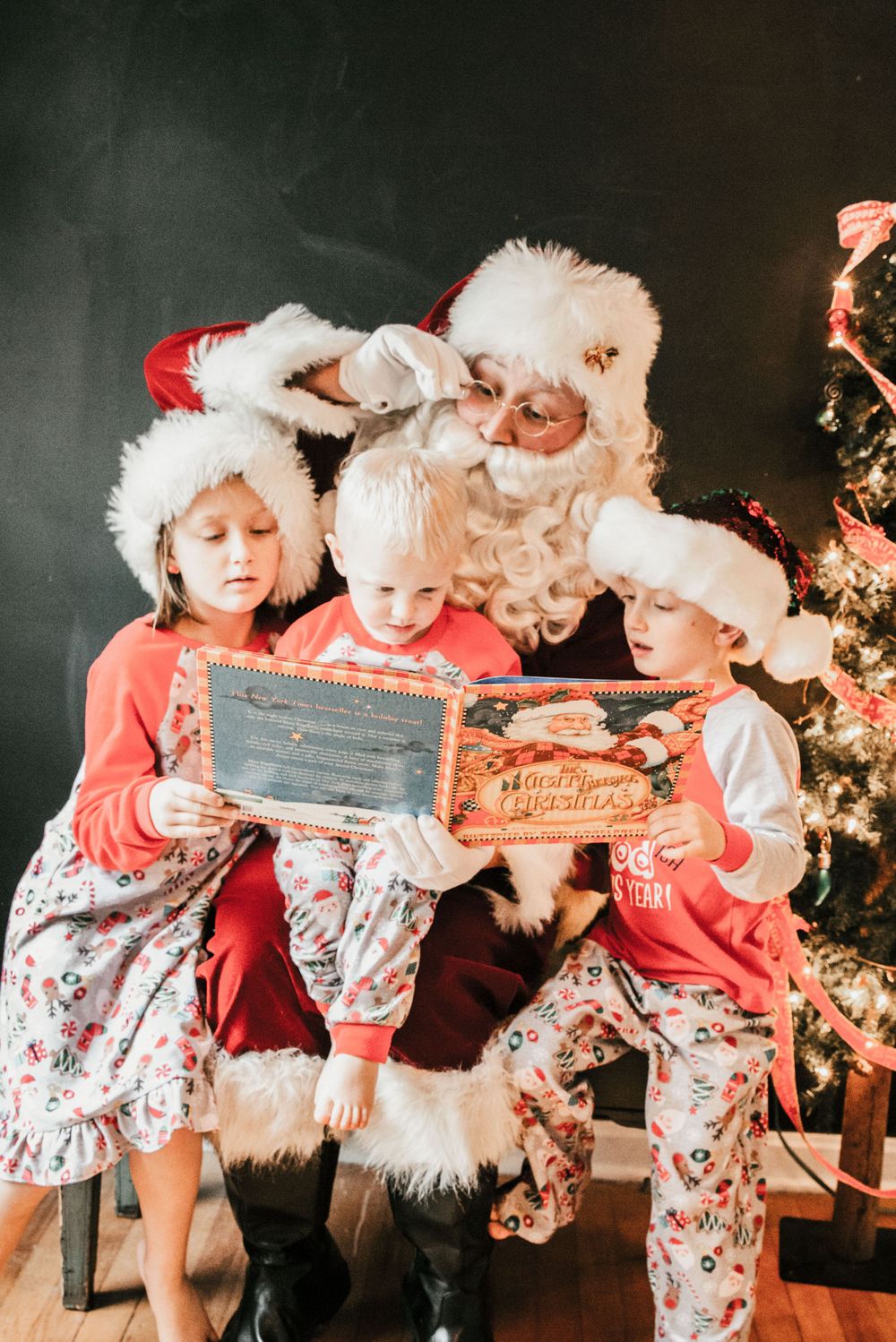 Santa reading to children in Christmas pajamas, Shiny Penny Studios, Cleveland