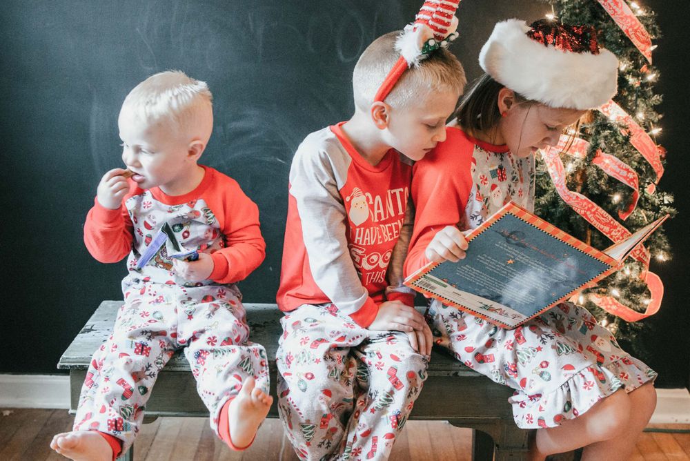 children reading book in Christmas pajamas, Shiny Penny Studios, Cleveland