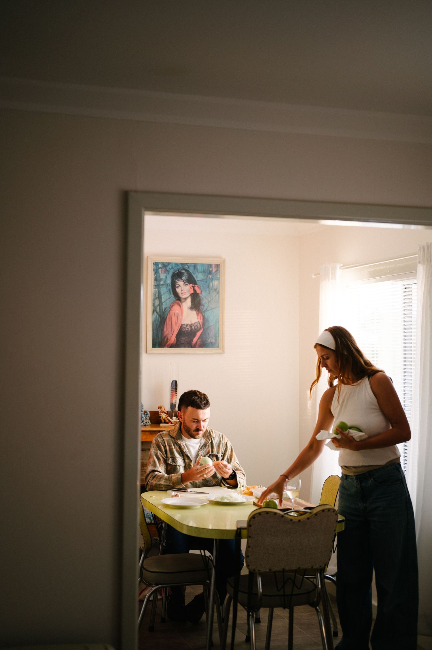 Mid-century modern dining room scene with vintage furniture and wall artwork.