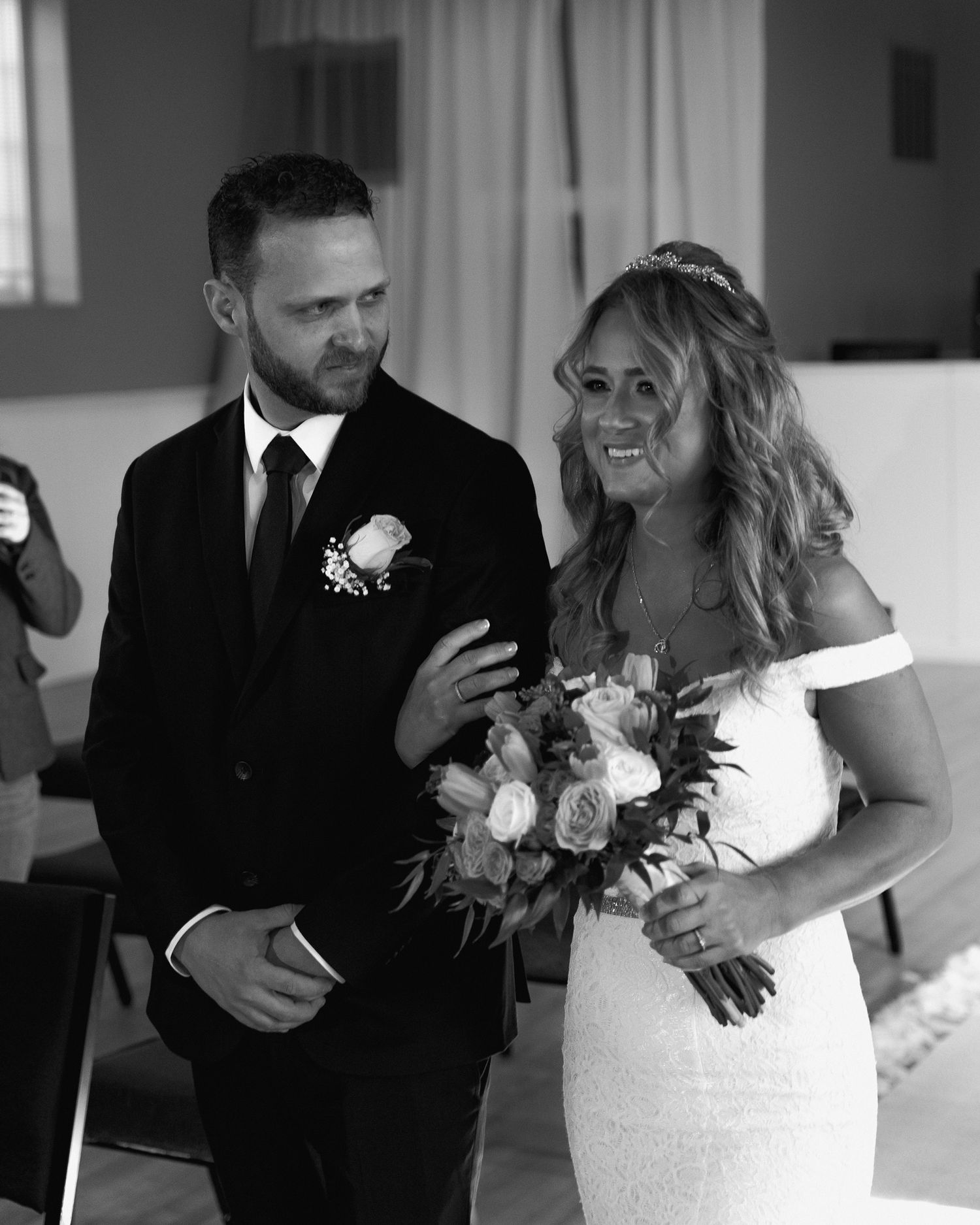 A happy couple shares a candid moment during their wedding day.